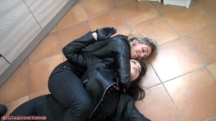 female fight by two spies in leather outfit