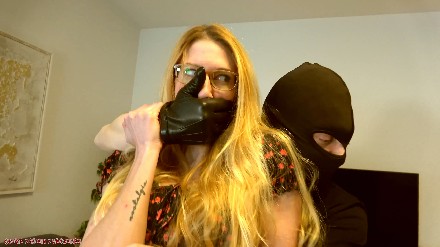 woman handgagged by a man in leather gloves