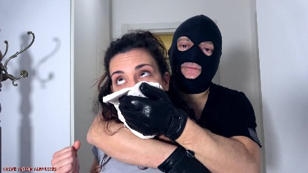 woman chloroformed by a man in balaclava and leather gloves